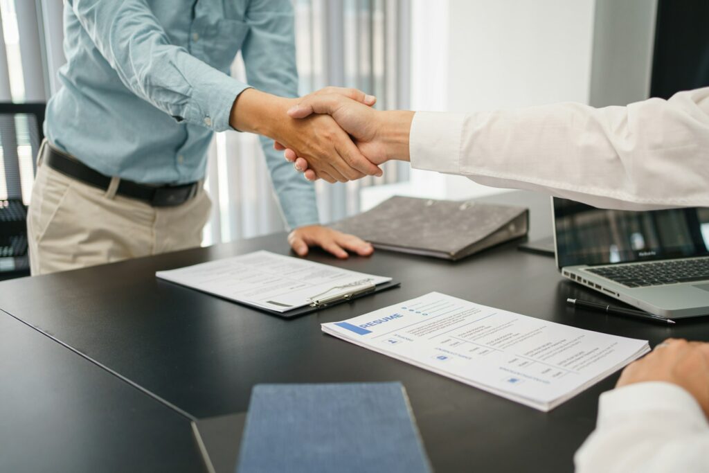 Recruitment concept, Male employer shaking hands with applicant to congratulation for new job.